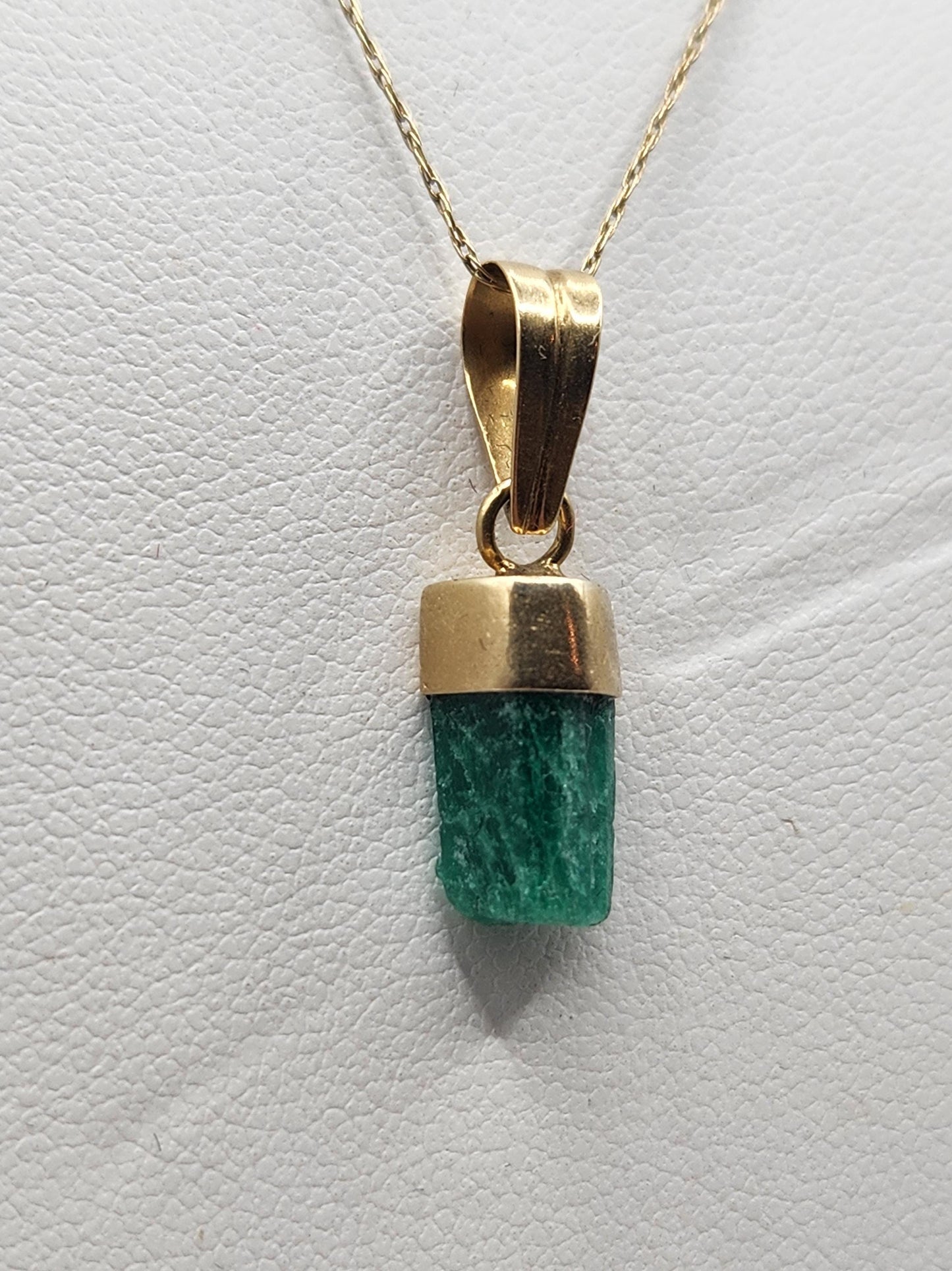 Pendiente de Esmeralda Natural sin Pulir, extraída de las minas de Muzo en Colombia, engastada en Oro de 18k, trabajo hecho a mano totalment